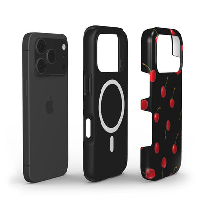 Trendy feminine phone case with vibrant red cherry pattern on black background, combining girly aesthetic with sleek protective style for popular phone models.
