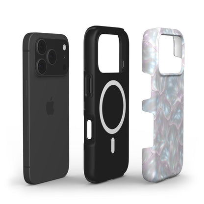 Black phone case with silver circle and a pearlescent white, pink, and silver multicolored protective cover in a trendy feminine design for phone accessories.