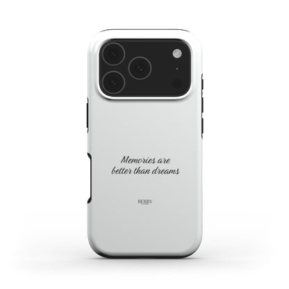 White phone case with elegant black script text reading "Memories are better than dreams" featuring a clean, trendy, and feminine design.