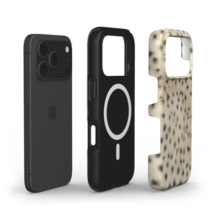 Black phone paired with a sleek black MagSafe case and a trendy fluffy cheetah patterned case in gold, bronze, brown, beige, multicolor, and black tones.