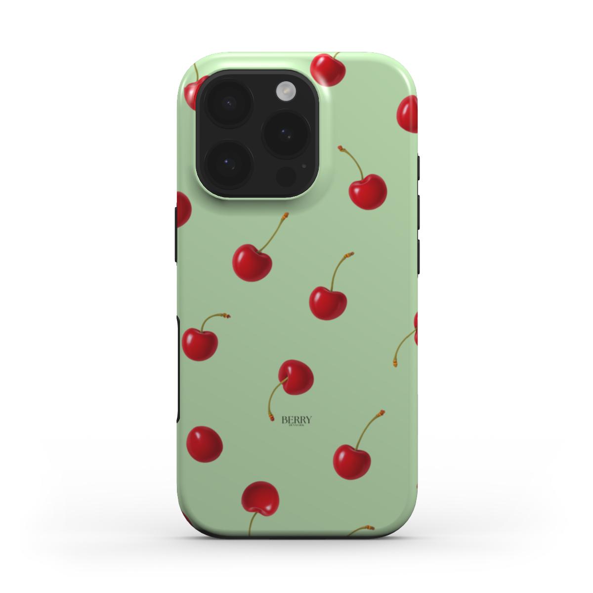 Trendy feminine phone case with a playful red cherry pattern on a multi-colored green background, combining girly charm and stylish aesthetic appeal.