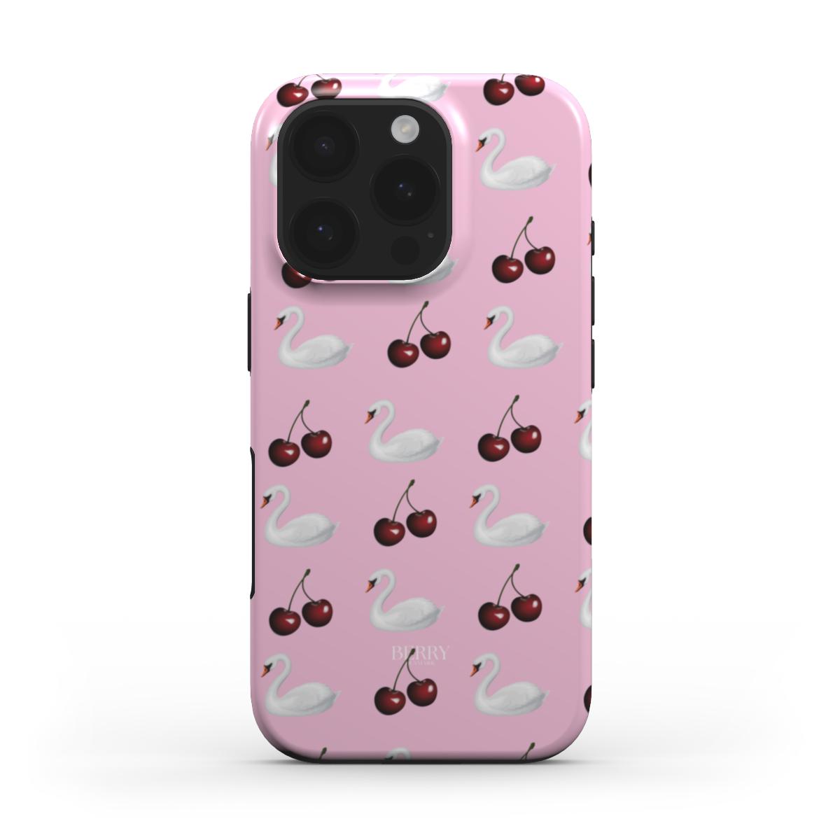 Pink phone case with a trendy pattern of white swans and red cherries, featuring a girly and feminine aesthetic perfect for that popular stylish look.