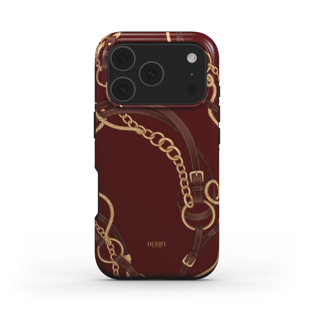 Trendy Burgundy Equestrian phone case with multicolored gold, brown, beige, and red chain and belt pattern, featuring a feminine and elegant design.