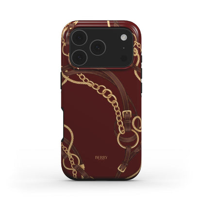 Trendy Burgundy Equestrian phone case with multicolored gold, brown, beige, and red chain and belt pattern, featuring a feminine and elegant design.